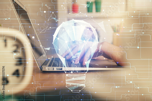 Double exposure of woman hands typing on computer and light bulb drawing. Idea concept.