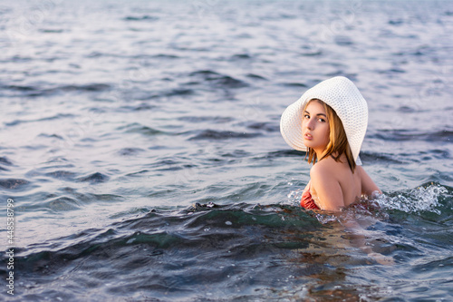 Fototapeta Naklejka Na Ścianę i Meble -  Portrait of beautiful young woman traveler in hat and swimsuit on vacation summer vacation