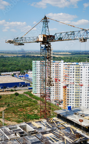 Crane and building against blue sky
