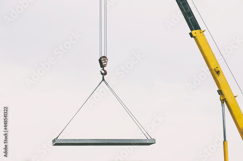 The building crane lifting the concrete plate