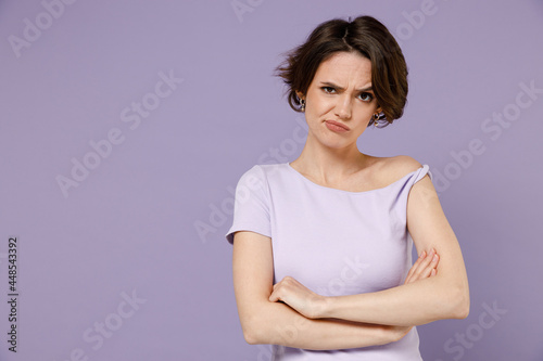 Photography Young frowning sad disappointed displeased woman 20s with bob haircut wearing white t-shirt hold hands crossed folded isolated on pastel purple background studio portrait