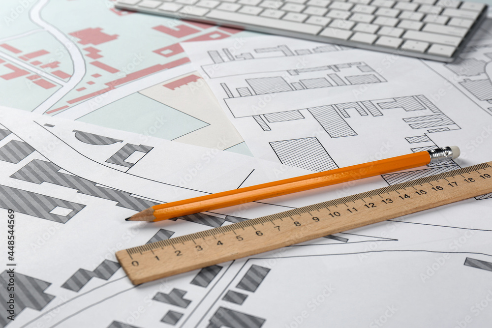 Pencil and ruler on cadastral maps of territory with buildings Pencil and ruler on cadastral maps of territory with buildings