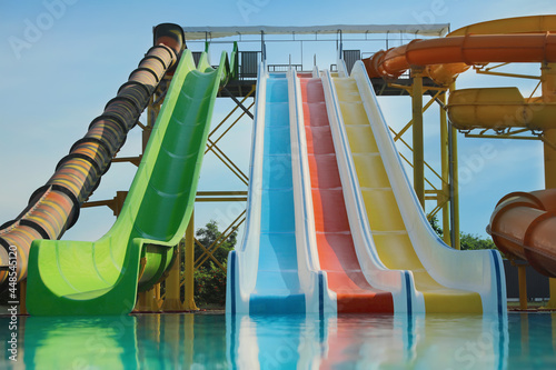 Beautiful view of water park with colorful slides and swimming pool on sunny day