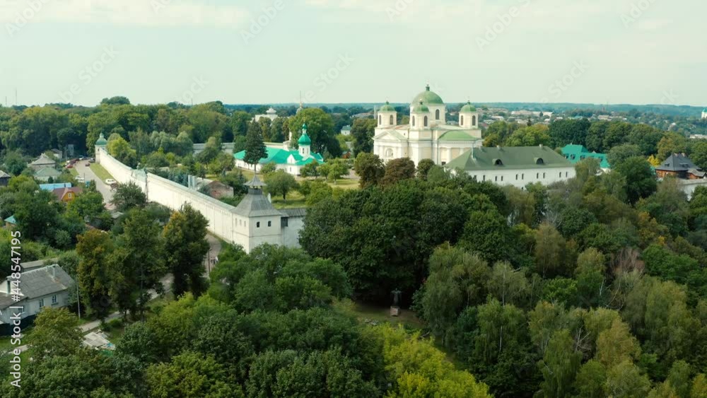 Aerial view over beautiful old church in small town Novgorod Seversky, Ukraine. Drone flying forward above old church, summer afternoon. Beautiful temple in a picturesque landscape place.. Aerial view over beautiful old church in small town Novgorod Seversky, Ukraine. Drone flying forward above old church, summer afternoon. Beautiful temple in a picturesque landscape place..