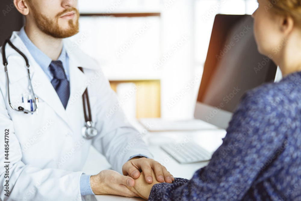 Friendly doctor reassuring female patient, close-up. Medical ethics and trust concept