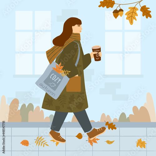 Girl in a coat and with a scarf around her neck walks down the autumn street. On the shoulder is a bag with colored leaves, hot coffee in her hands. Vector illustration in flat style