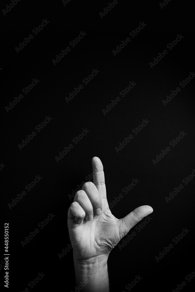 B&W image of hand demonstrating ASL sign language letter L with empty copy space B&W image of hand demonstrating ASL sign language letter L with empty copy space