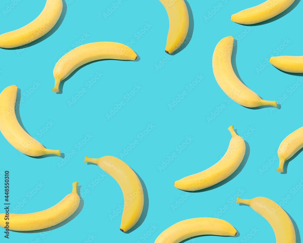 Trendy summer composition made of  yellow bananas on pastel blue background with copy space.