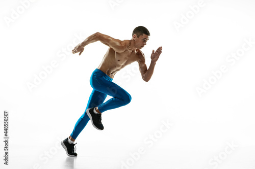 One Caucasian professional male athlete  runner training isolated on white studio background. Muscular  sportive man. Concept of sport  healthy lifestyle