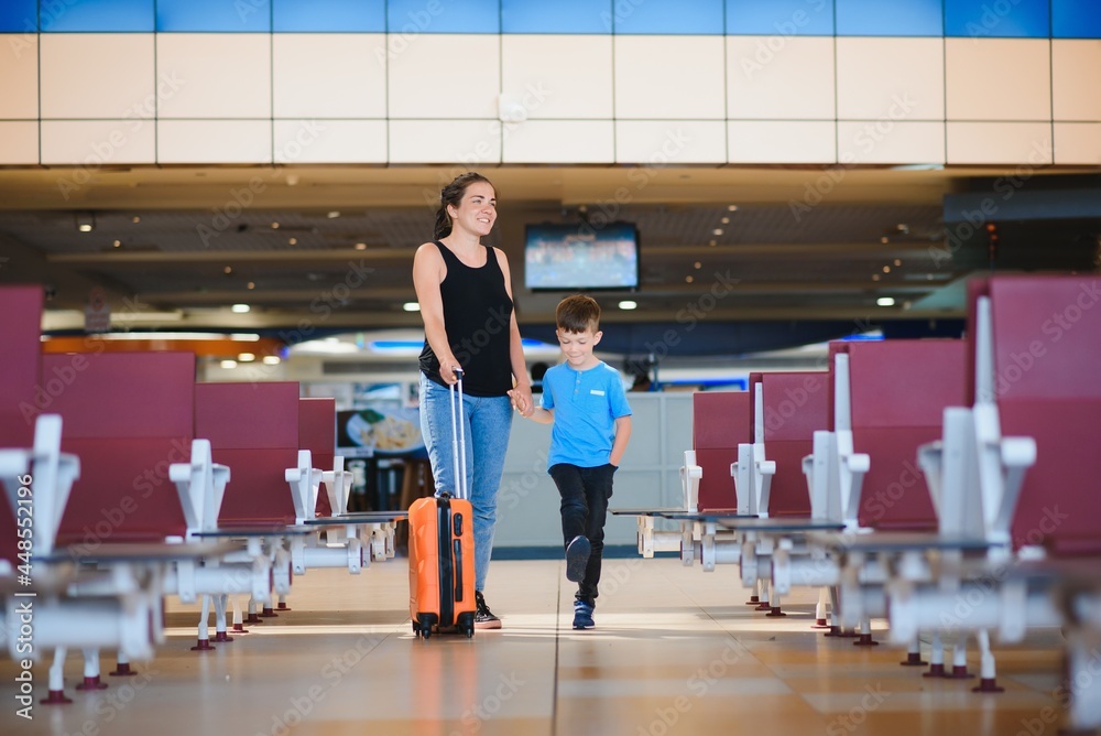 Woman and her child passing through the airport terminal