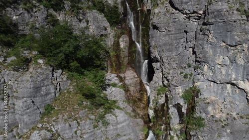 Beautiful Theth waterfall near Theth village in Albanian alps mountains. Majestic cascade waterfall into the forest in slow motion, Accursed mountains, Albania photo