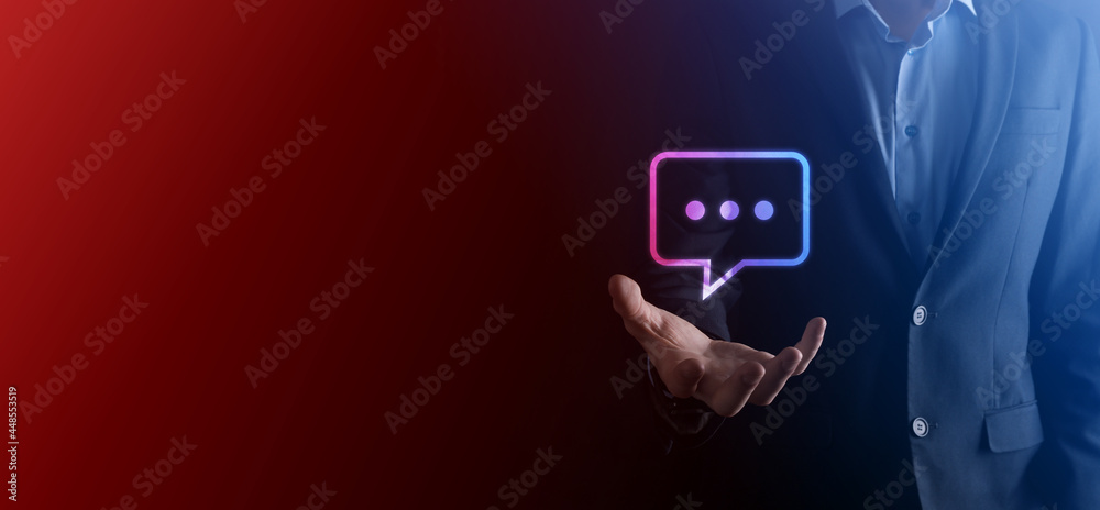 Businessman holding a message icon, bubble talk notification sign in his hands. Chat icon, sms icon, comments icon, speech bubbles
