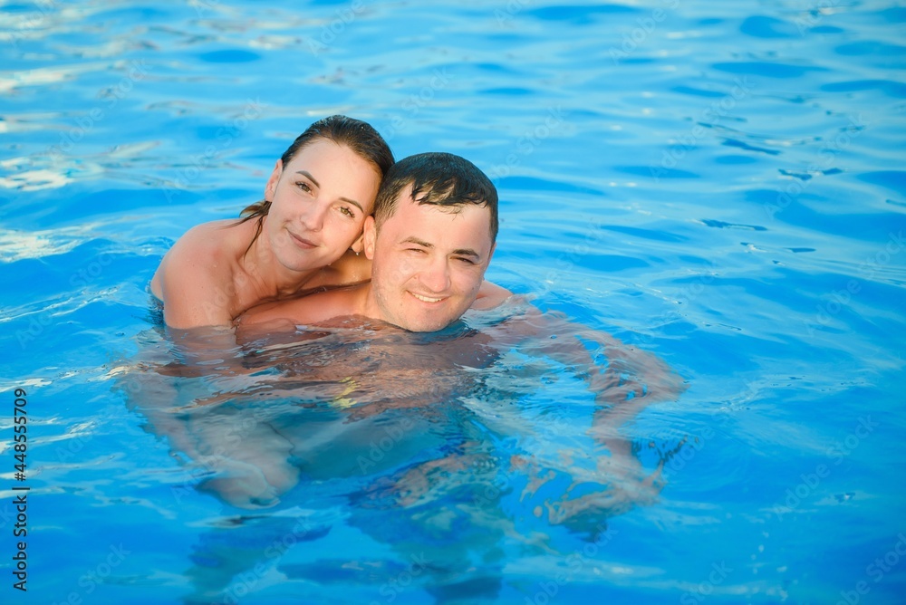 Portrait of a smiling couple in a swimming pool