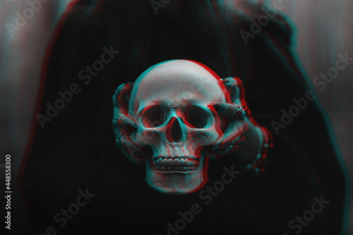 skull of a dead man in the hands of a witch witch photo