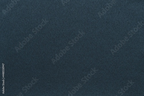 grooved and solid textured grained fabric background close-up for rough background or dark blue wallpaper