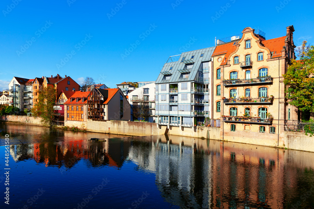 Fototapeta premium Residential houses situated on the river shore . Nuremberg residential district and Pegnitz river