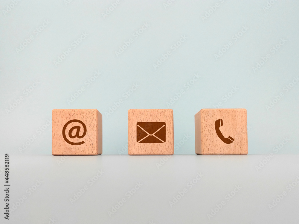 Contact us concept, wooden blocks with email, mail and telephone icons, web page contact us or e-mail marketing Contact us concept, wooden blocks with email, mail and telephone icons, web page contact us or e-mail marketing