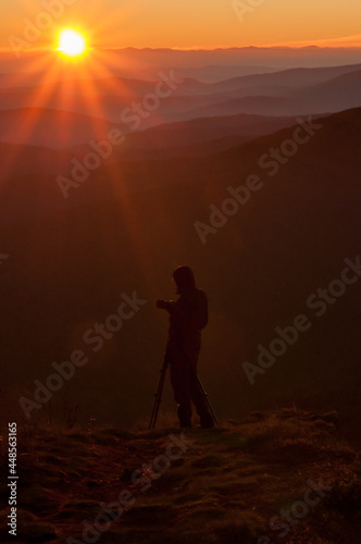 A photographer watching the sunrise at the top of Po  onina Wetli  ska  Bieszczady Mountains  Carpathians