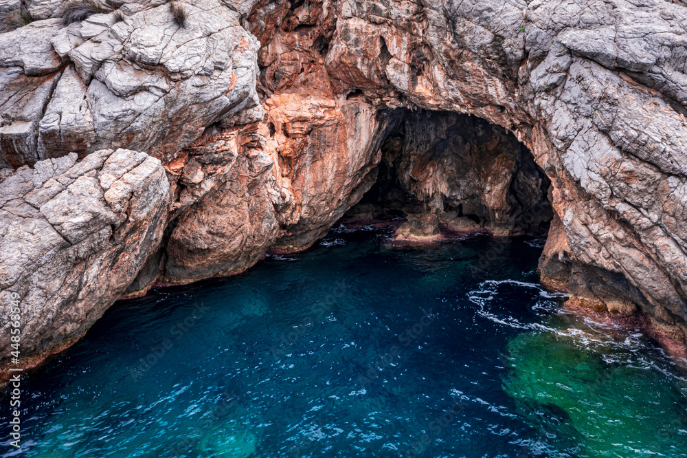 rocky cave on the blue crystal clear sea rocky cave on the blue crystal clear sea