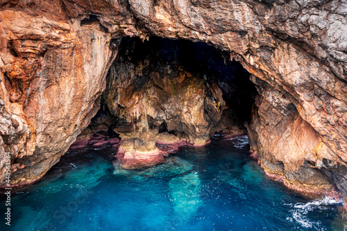 rocky cave on the blue crystal clear sea 