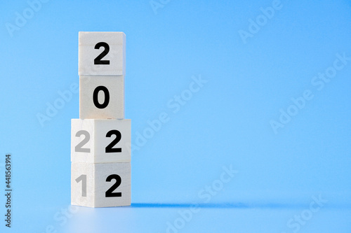 wooden cube block changing from New year 2021 to 2022 concept on isolated background with copy space            