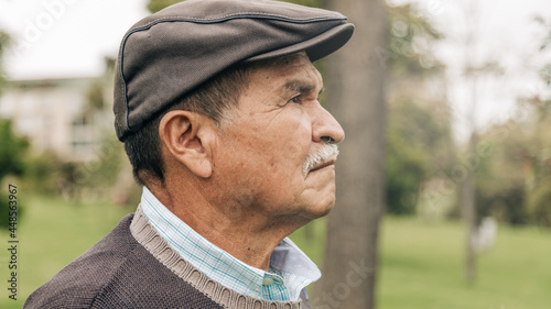 serious senior male, getting fresh air in the park taking a walk