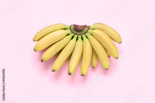 Bunch of ripe baby bananas on pink background, top view © New Africa