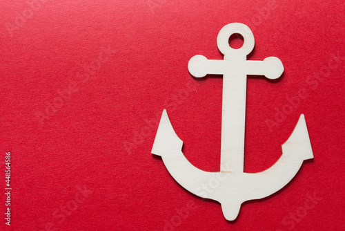 isolated laser-cut plywood anchor shapes on a red paper background photo