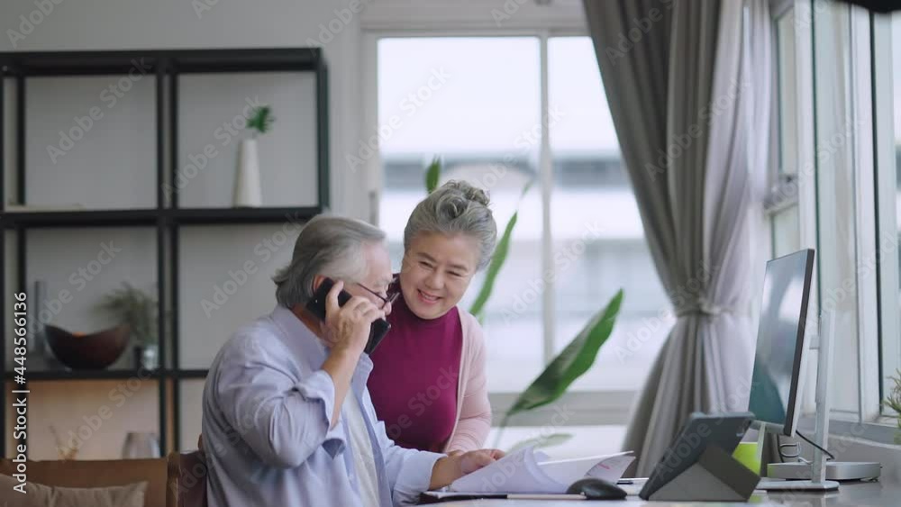 old senior asian retired people entrepreneur working together at home,home isolation remote jobs work with desktop and smartphone technology device work from home