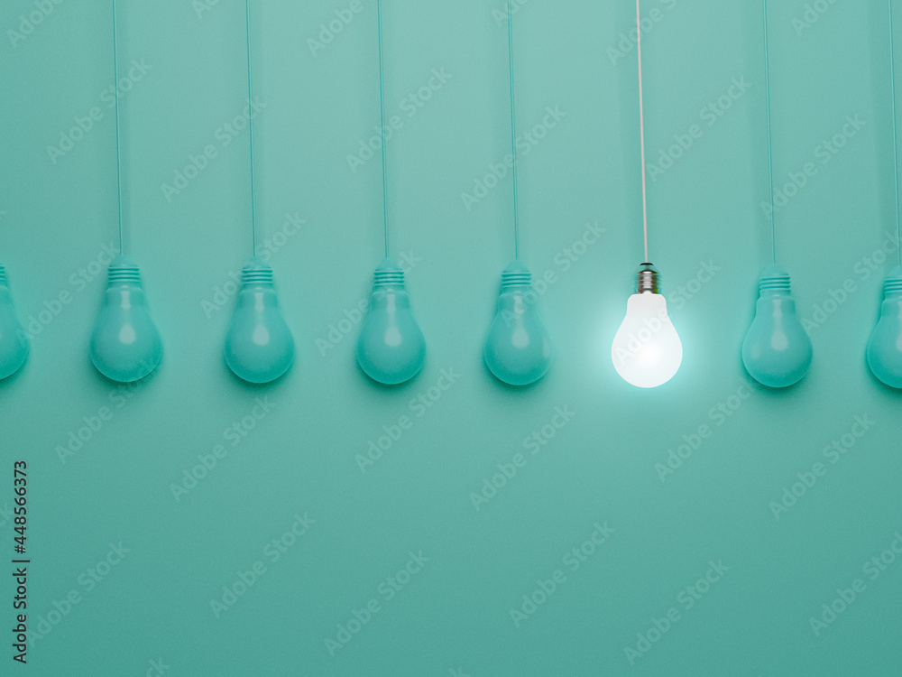 One hanging light bulb glowing from others bulbs on blue background for outstanding ,different creative thinking idea and innovation concept by 3d render. One hanging light bulb glowing from others bulbs on blue background for outstanding ,different creative thinking idea and innovation concept by 3d render.