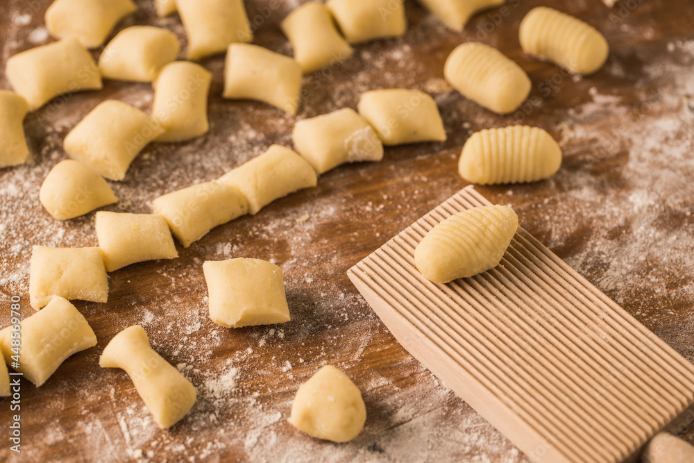 Raw pieces of dough near ribbed board Raw pieces of dough near ribbed board