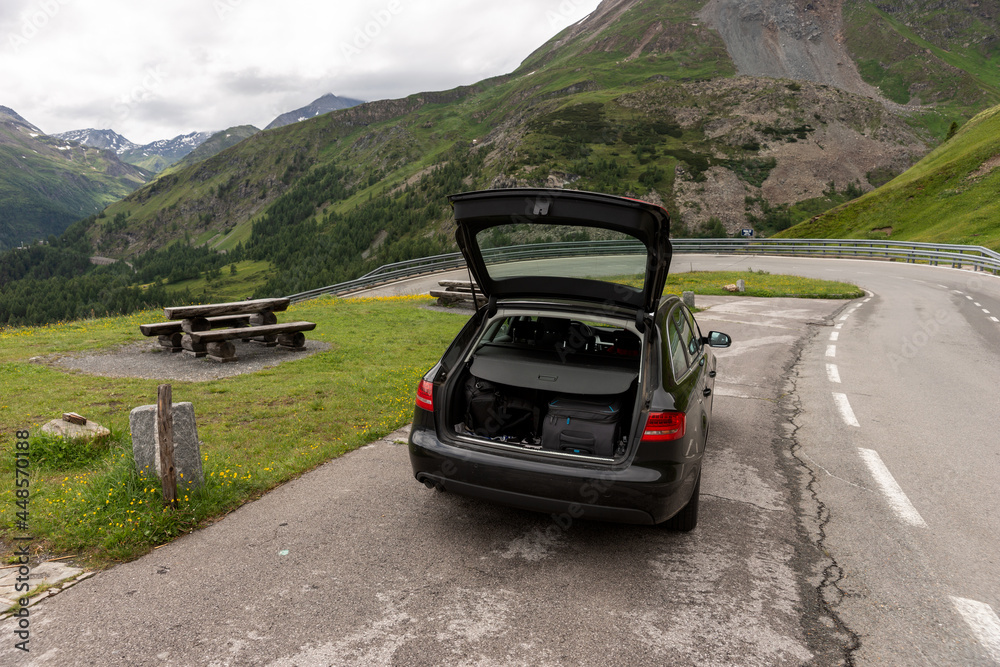 The black car is parked at the rest area on the Grossglockner High Alpine Road. Austria