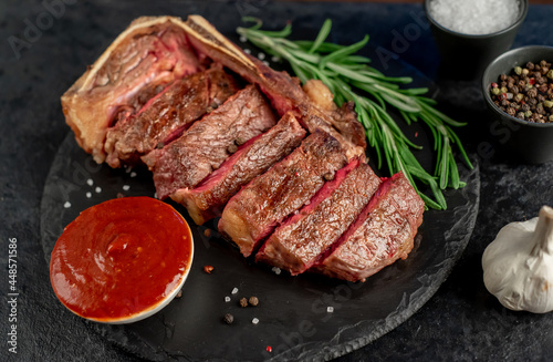 Grilled marbled beef New York steak on stone background 