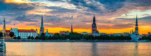 Colorful sunrise and waterfront view on historical district of Riga - the cap...