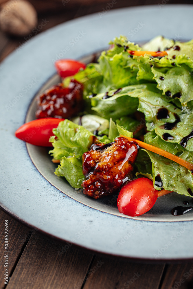 Salad with lettuce and fried duck on wooden background Salad with lettuce and fried duck on wooden background