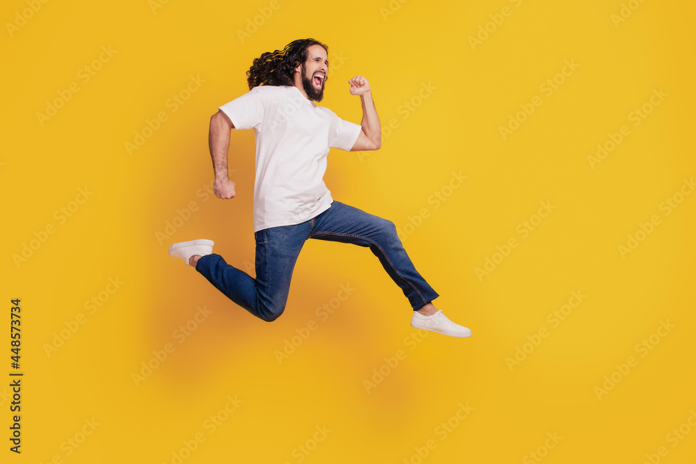 Profile portrait of funny positive casual dreamy guy run fast rush jump on yellow background