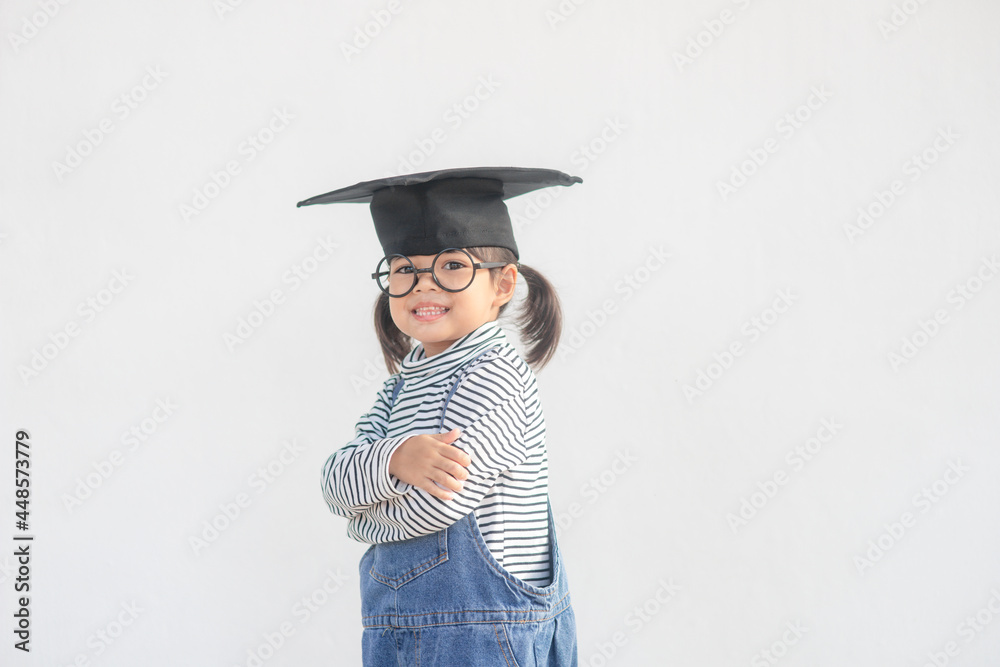 Happy Asian school kid graduate in graduation cap Happy Asian school kid graduate in graduation cap