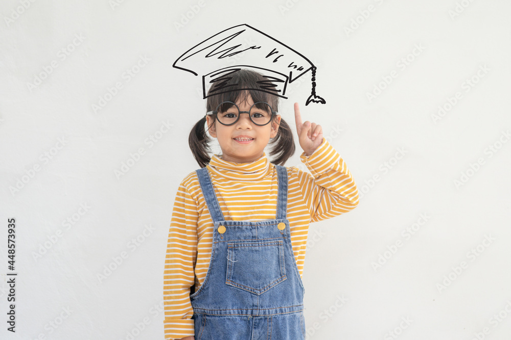 Happy Asian school kid graduate in graduation cap Happy Asian school kid graduate in graduation cap