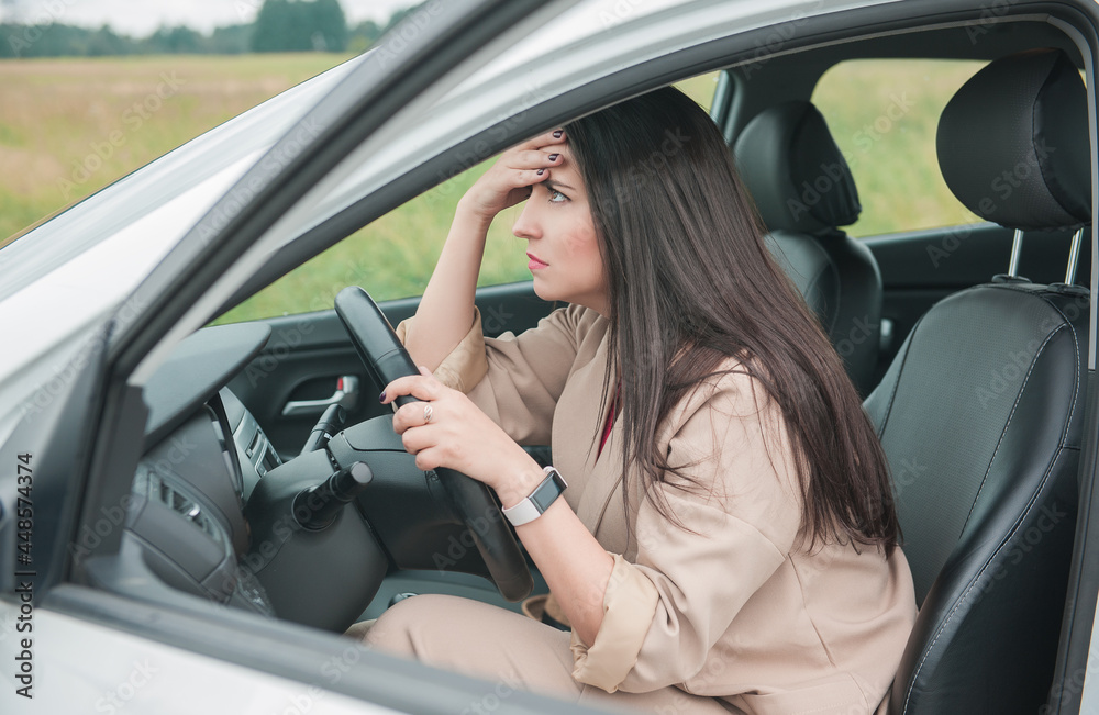 Sad woman driver sitting inside the car Sad woman driver sitting inside the car