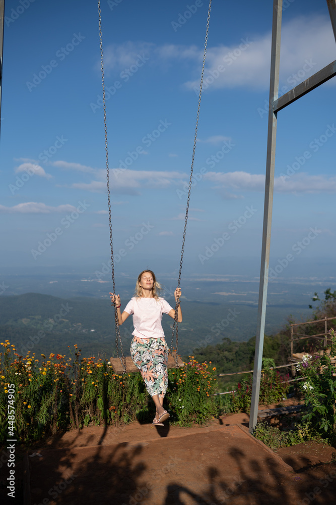 Woman is swinging on a swing in Mon Jam Woman is swinging on a swing in Mon Jam