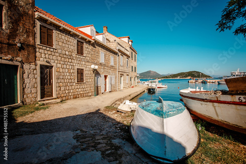 An old abandoned wooden boat off the coast of an island in Croatia. View of the fishing village