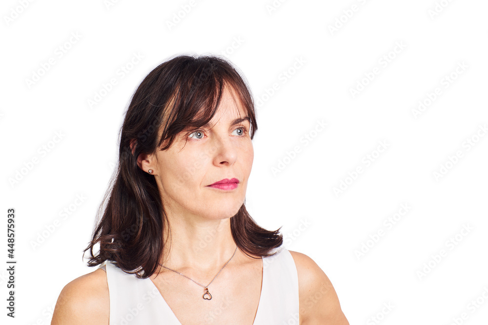 Portrait of a beautiful woman in her fifties white blouse on a white background with a serious look on her face. Portrait of a beautiful woman in her fifties white blouse on a white background with a serious look on her face.