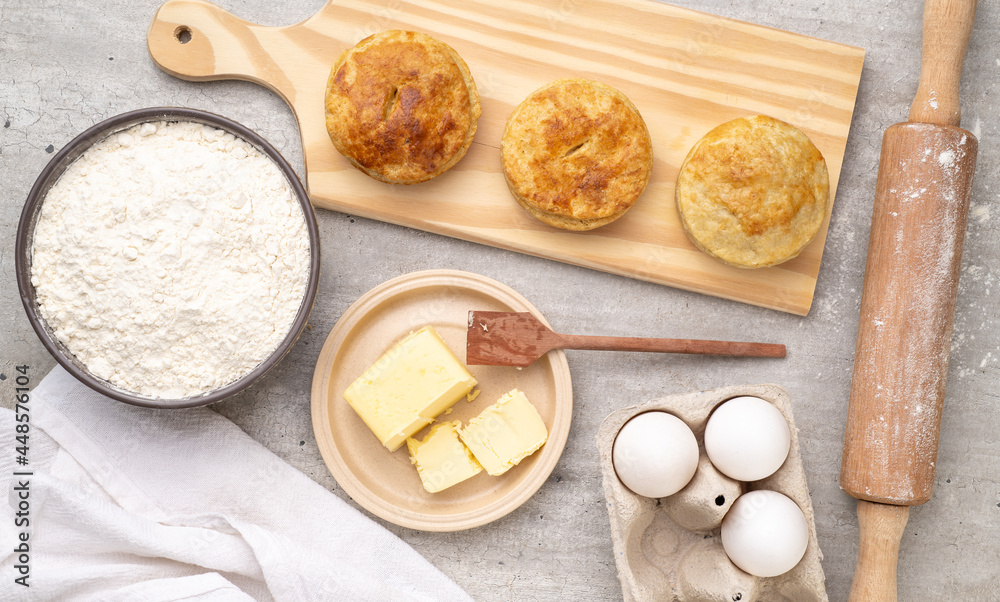 Homemade pies over wooden board with ingredients Homemade pies over wooden board with ingredients