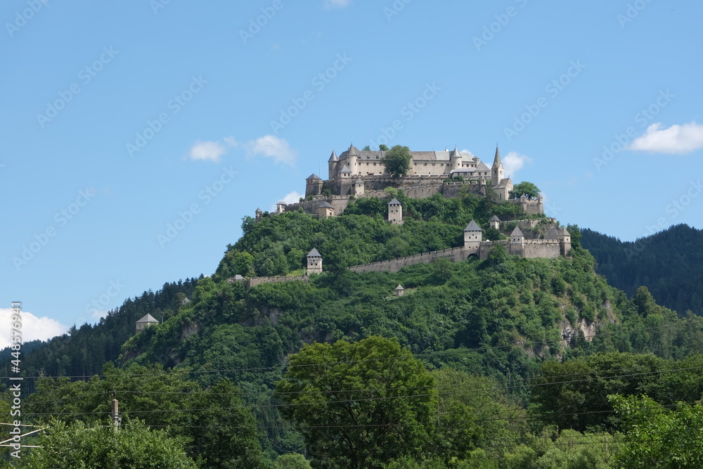 Launsdorf, Austria - July 9, 2021: Burg Hochosterwitz. A shot on the move from the driver window of an electric car. Sunny summer day. POV first person view shot on a mountain road.