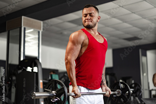 Strong man athlete exercise in gym, close up portrait