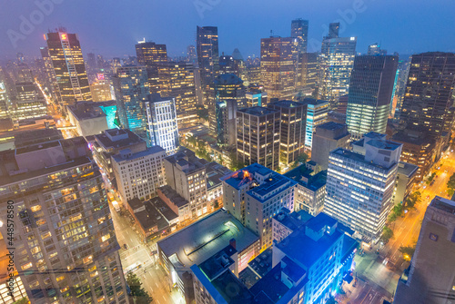 VANCOUVER, CANADA - AUGUST 10, 2017: Building lights of Downtown, aerial view. Vancouver attracts 10 million tourists annually