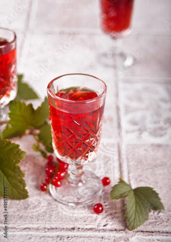 glasses of red currant brandy liqueur with ripe berries