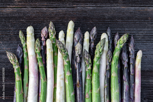 Green, purple and white asparagus sprouts