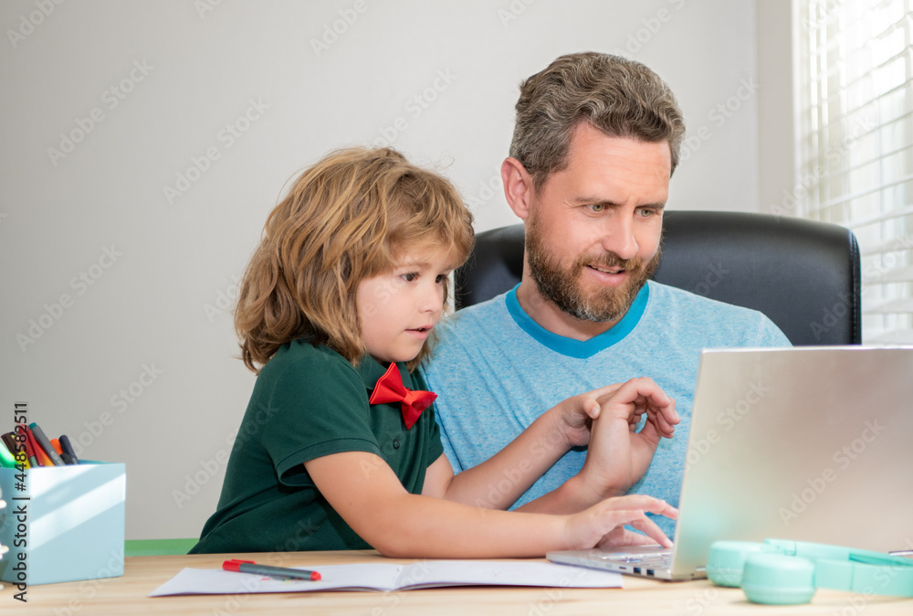 back to school. dad and son use computer at home. family and parenthood blog. back to school. dad and son use computer at home. family and parenthood blog.