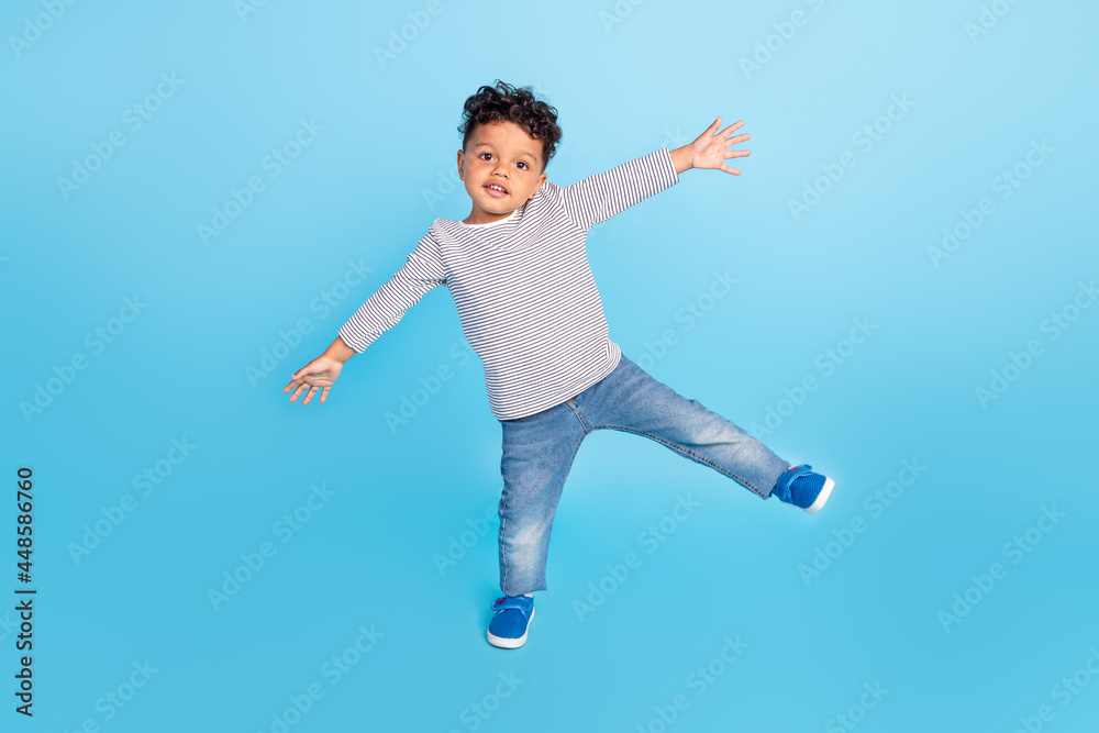 Full length body size view of nice cheery boy dancing having fun isolated over bright blue color background